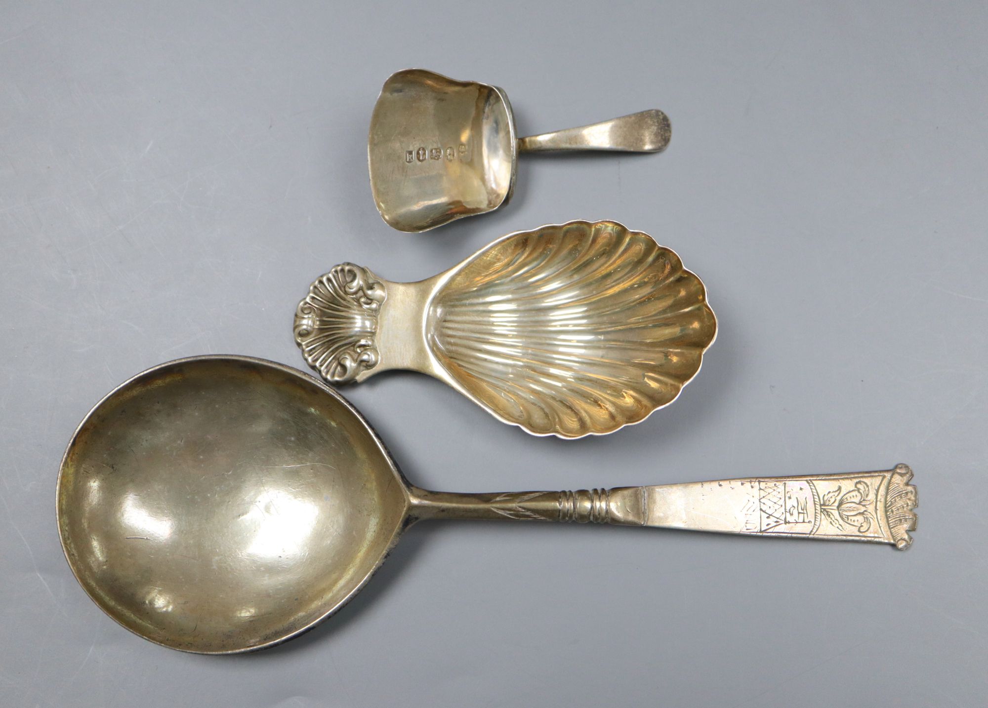 An early 18th century Dutch white metal spoon, the bowl underside monogrammed TIS-KLD and two silver caddy spoons.